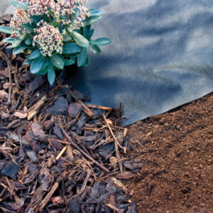Roll of spun bonded weed control fabric for use under mulch or bark