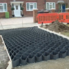 Bodcell cellular tree root protection panels fixed to the ground beneath a vehicle route near a tree