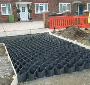 Bodcell cellular tree root protection panels fixed to the ground beneath a vehicle route near a tree